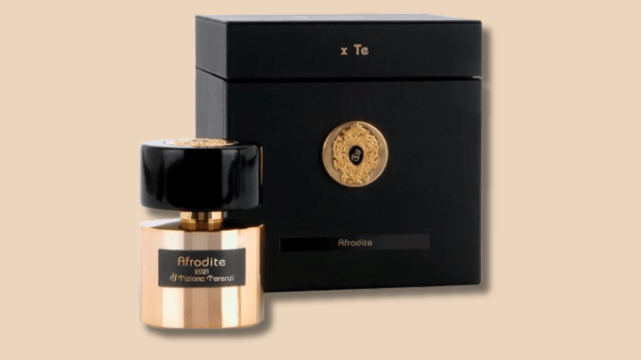 a bottle of perfume with a black box and a gold medal