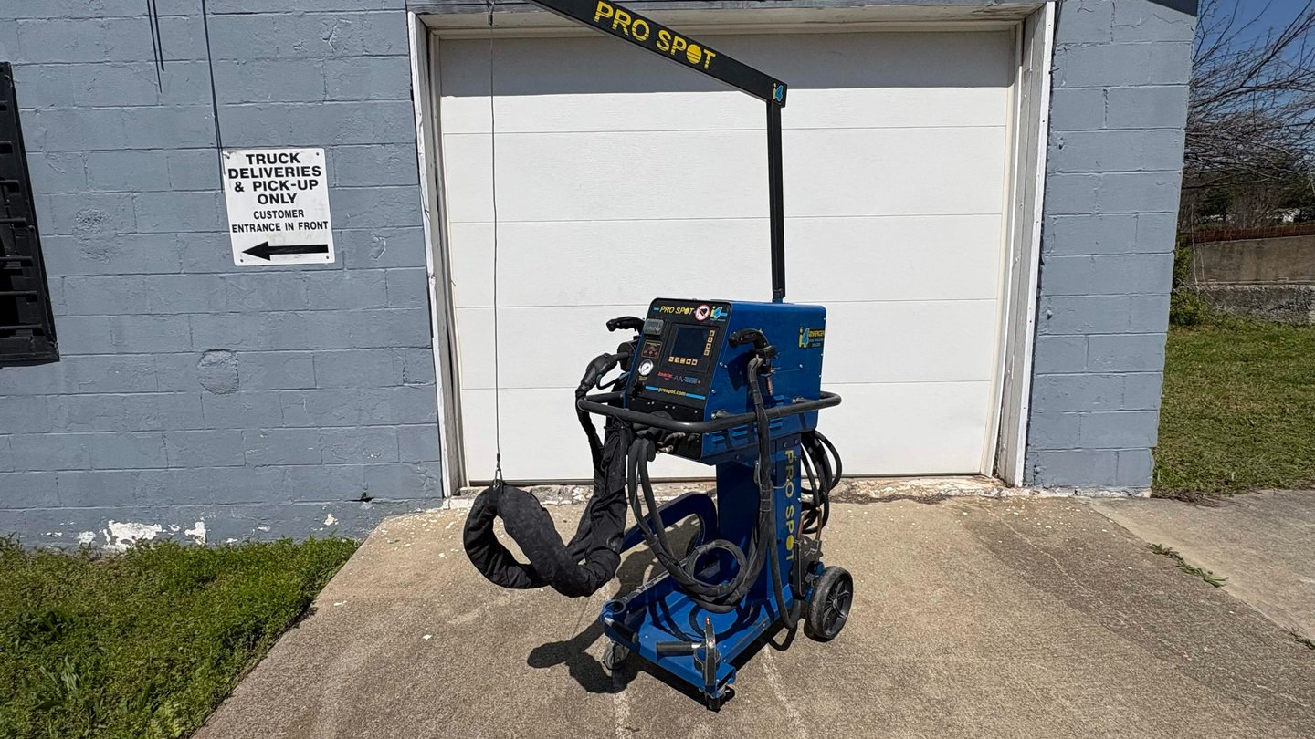 Professional Pro Spot blue mobile spot welder for automotive body repair parked outside a garage.