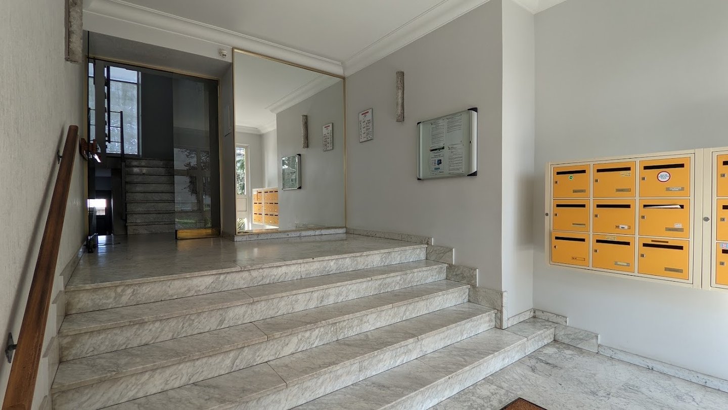 a staircase leading to a staircase way with mailboxes
