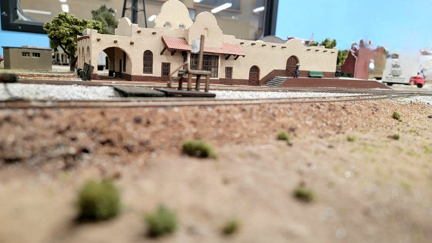Gilbert Train Station in Gilbert, Arizona. Tan stucco building with curved arches along the roof.