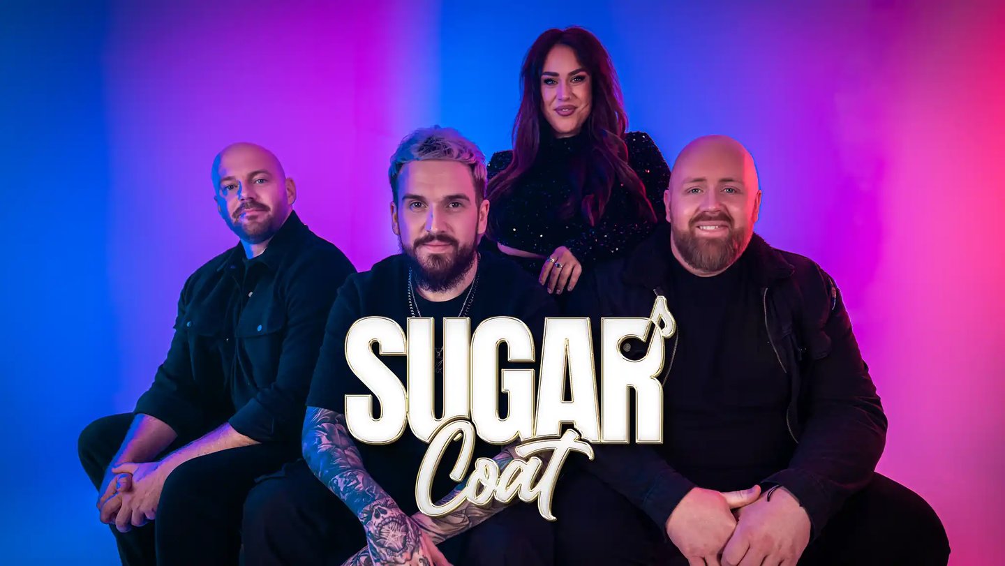 a group of people sitting on a couch with a man in a black shirt