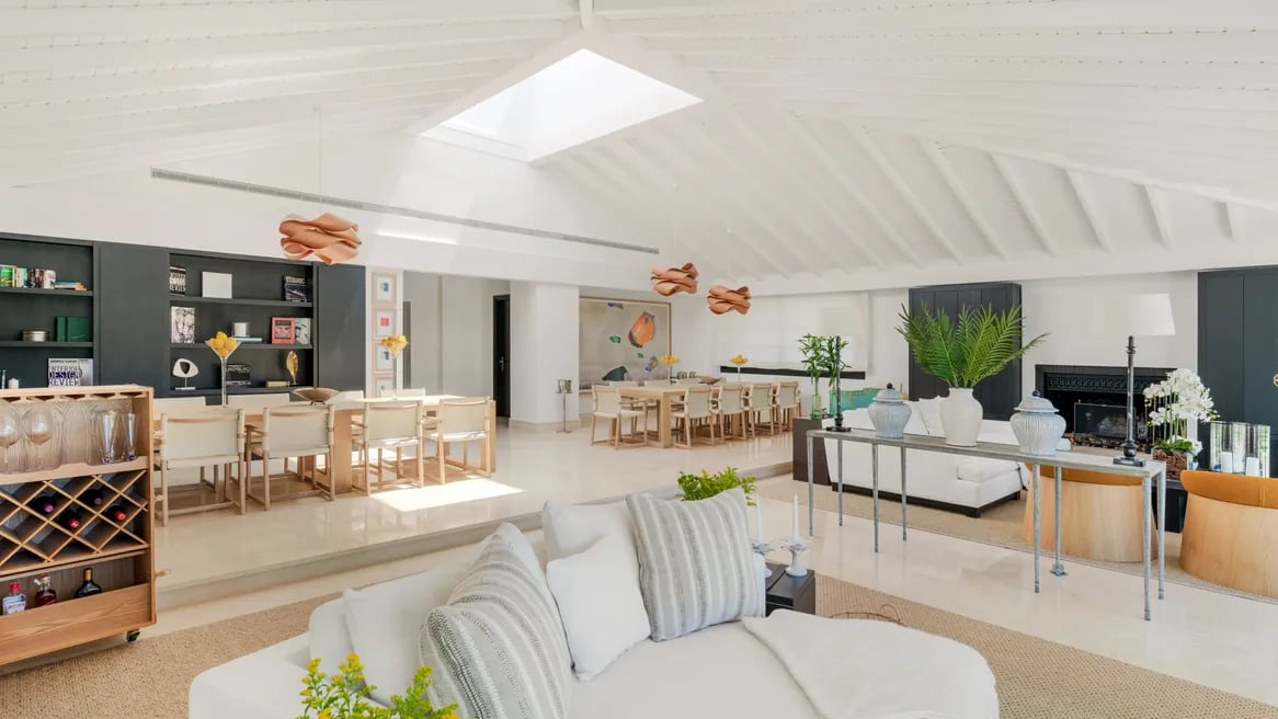 Spacious open-plan dining and lounge area with skylight at Villa El Olivo, Marbella