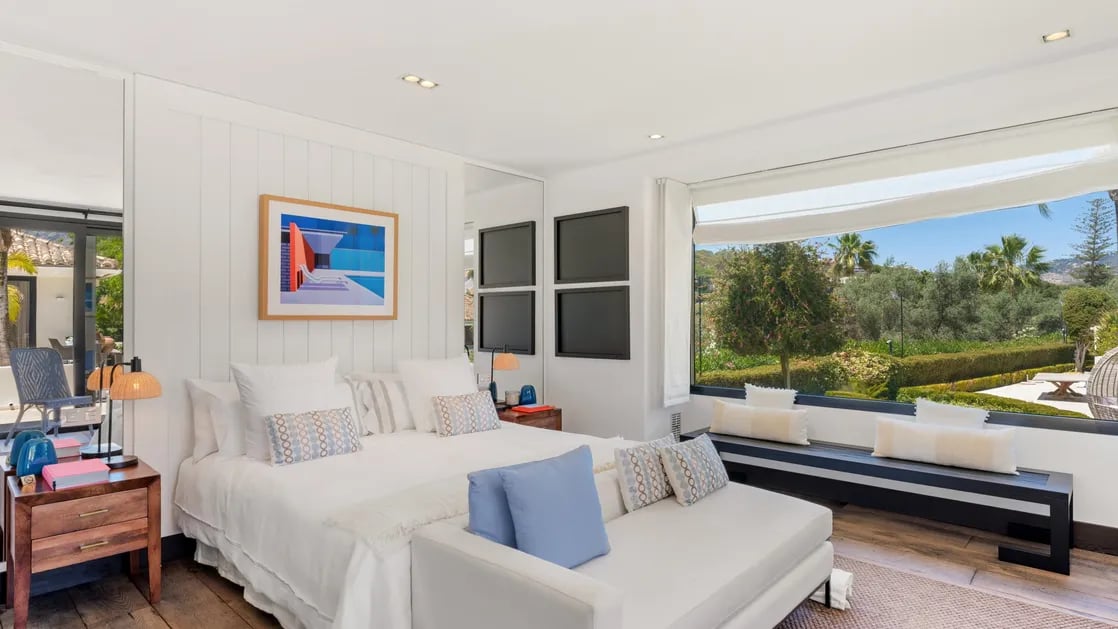 Guest suite with seating nook and garden views at Villa El Olivo, Marbella