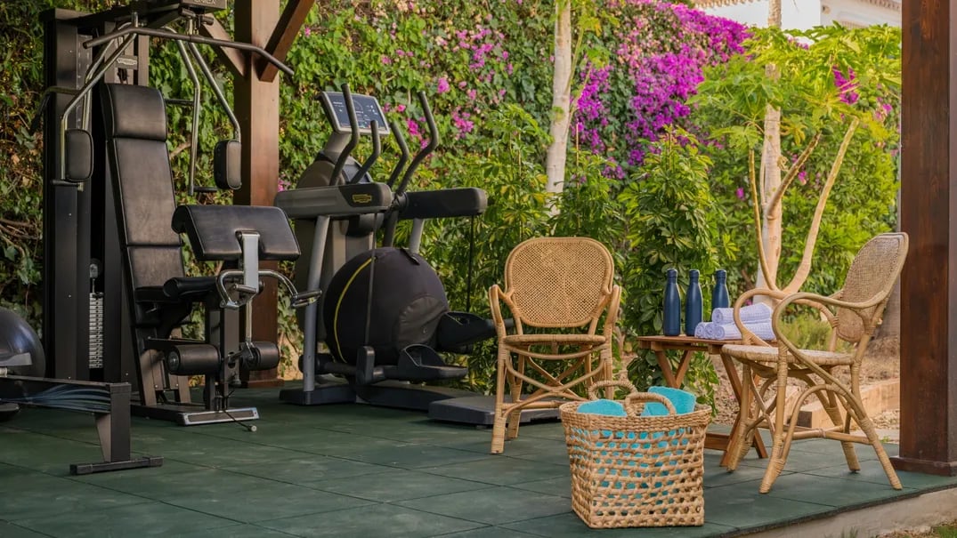 Outdoor gym amid tropical gardens at Villa El Olivo, Marbe