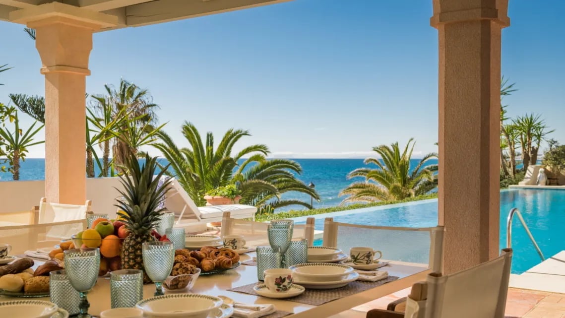 Poolside dining area at Villa El Rincon with sea views