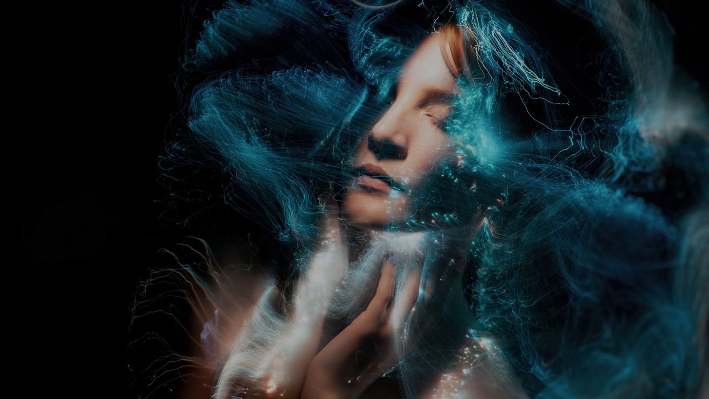 A digital artwork of a woman's face blended with abstract light effects, showcasing Photoshop for artistic expression.