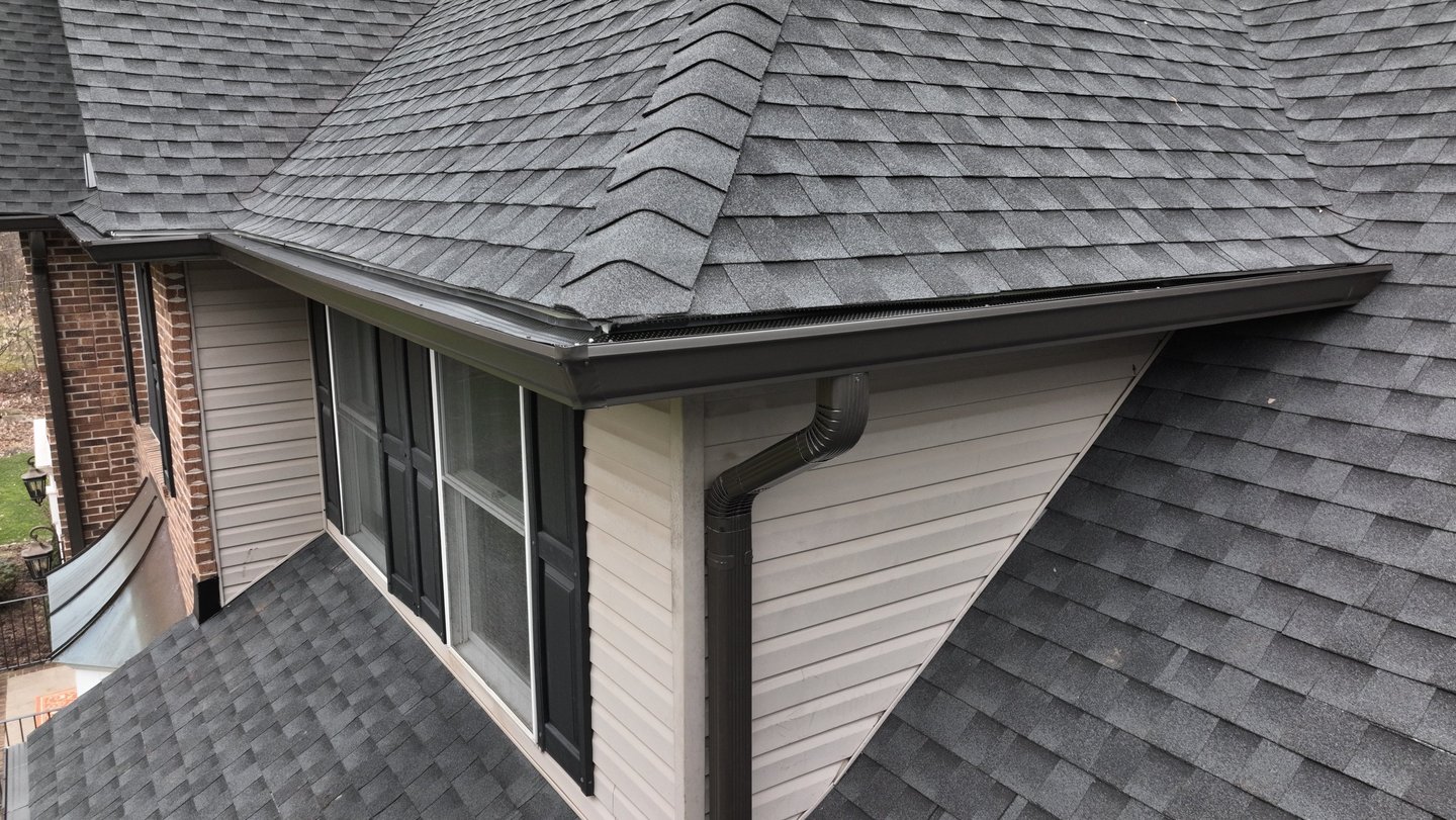Seamless gutter installation and asphalt shingle roof on residential home in New Jersey