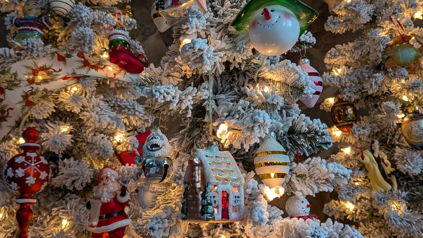 Close-up of decorated holiday tree with ornaments used for seasonal home and garden styling.