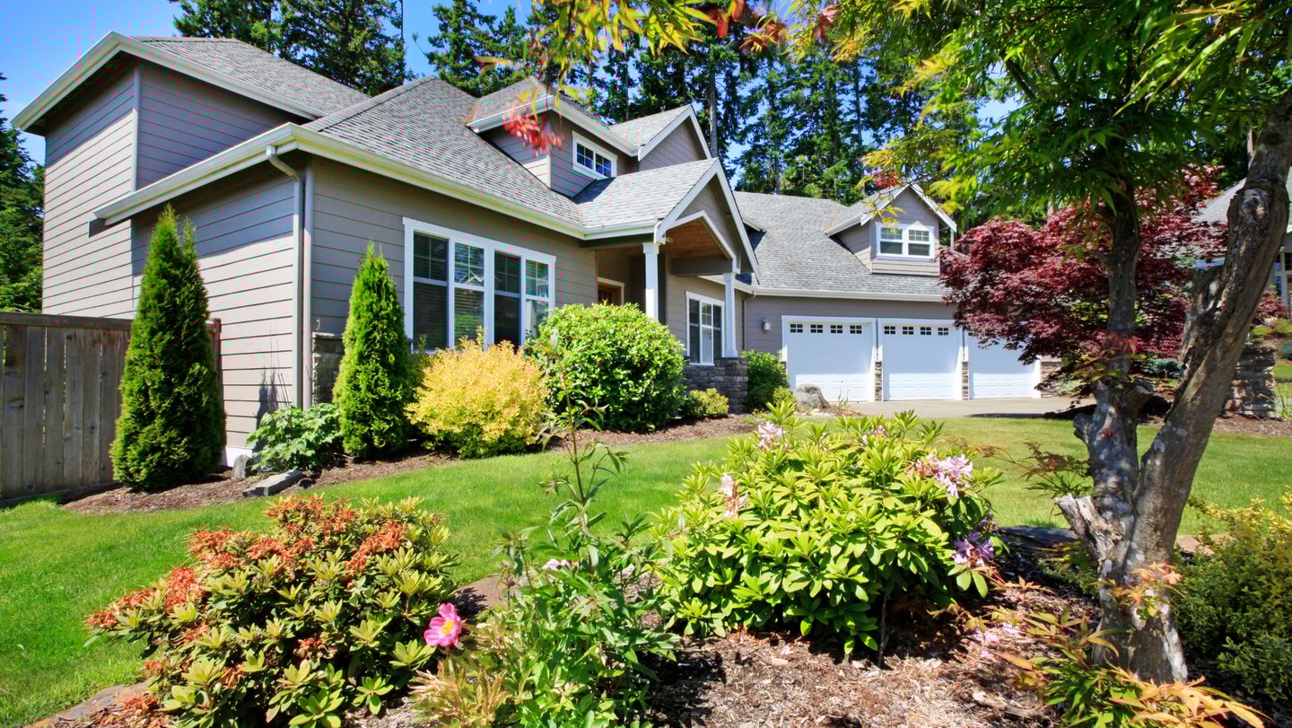 Residential landscape with layered perennials, shrubs, and a well-kept WNY garden.