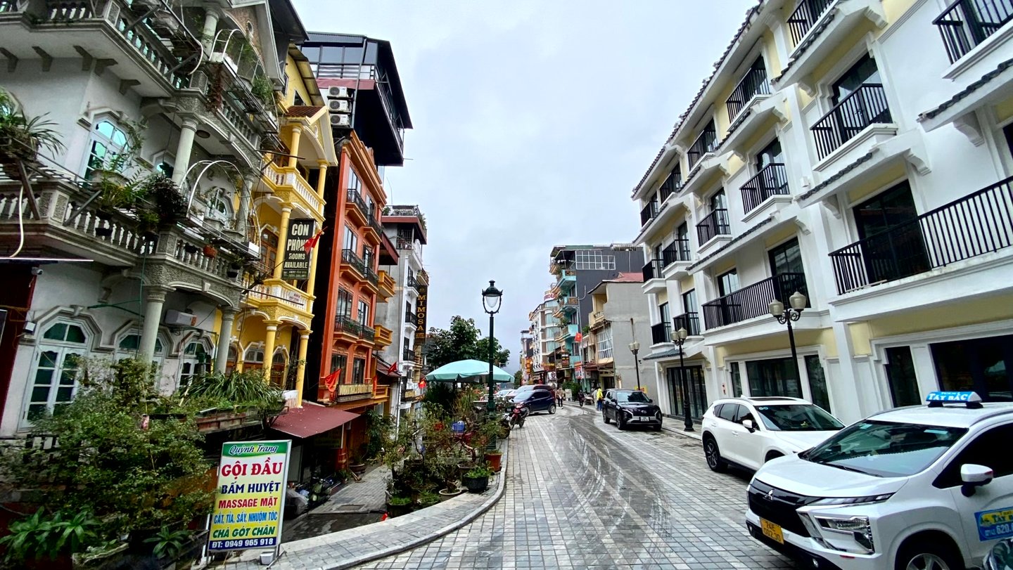 a street scene with a car parked on the side of the road