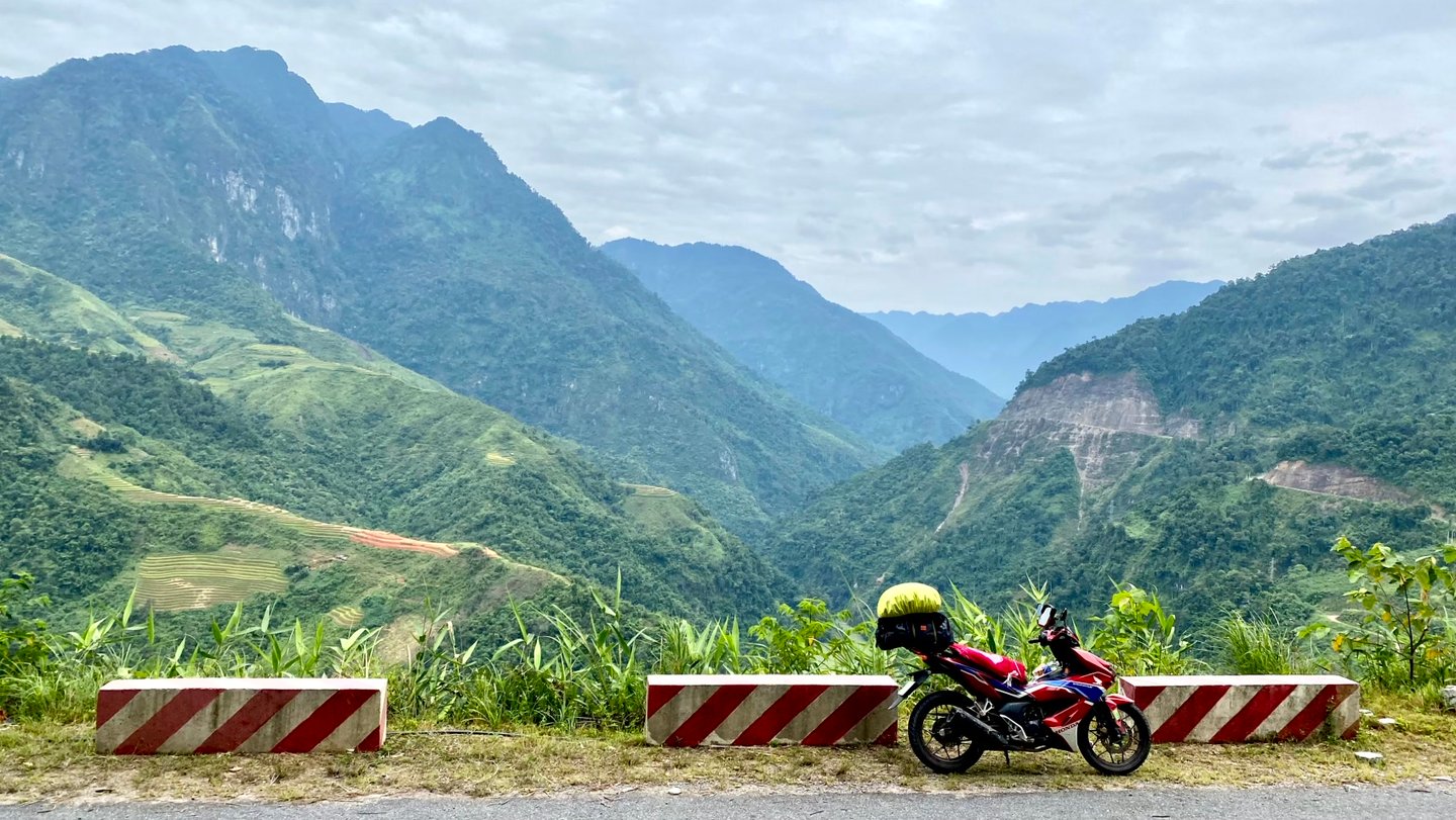a motorcycle parked on a mountain side road