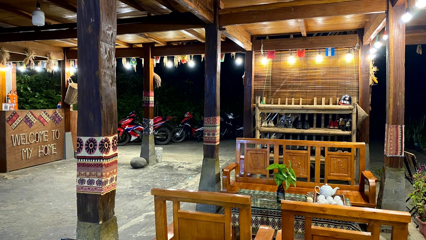 a homestay with a wooden table and chairs