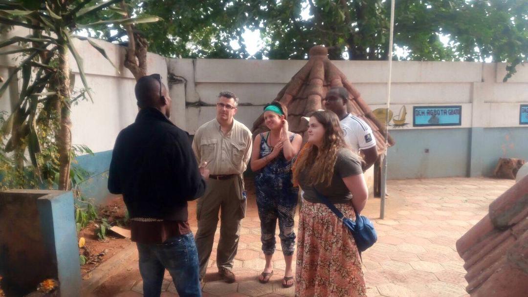 Dahomey African Tours Guide leading tourists in Pythons Temple in Benin