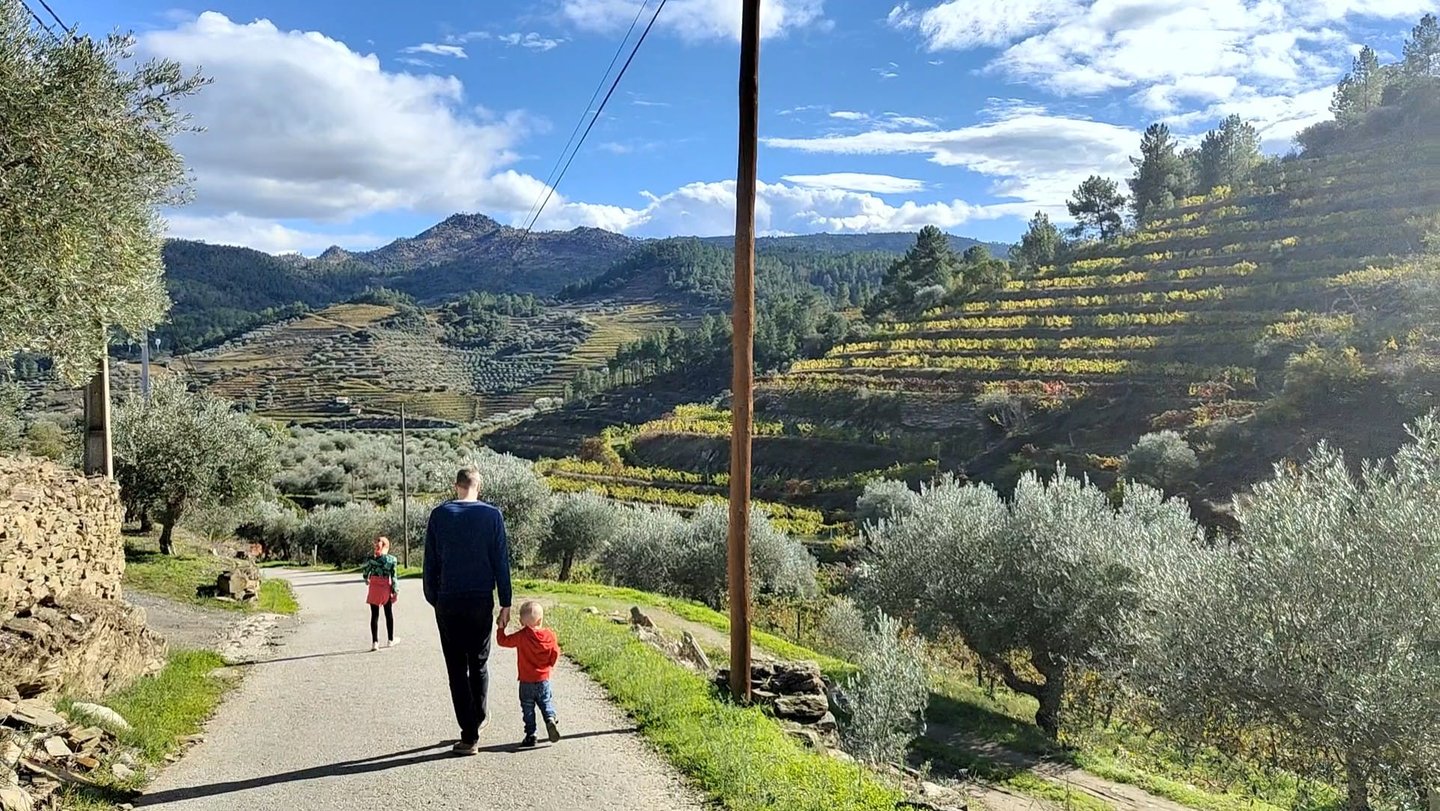 a man and two children walking down a path