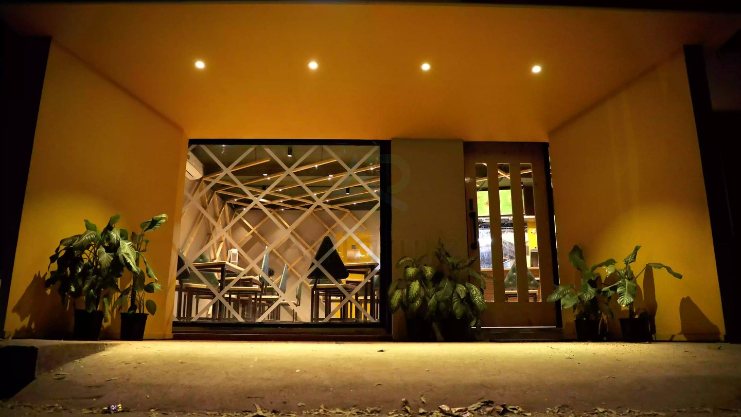 a restaurant entrance with a sign that says,Kone Zone