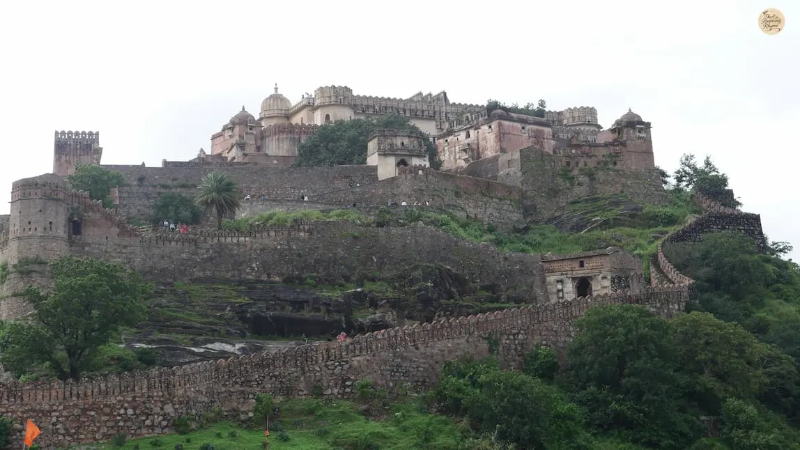 View of Kumbhalgarh Fort’s massive fortification walls winding through the Aravalli hills in Rajasthan.