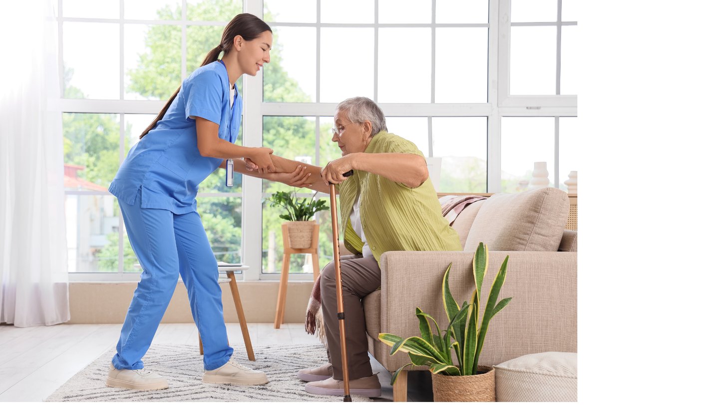 Caregiver helping a female patient to stand up