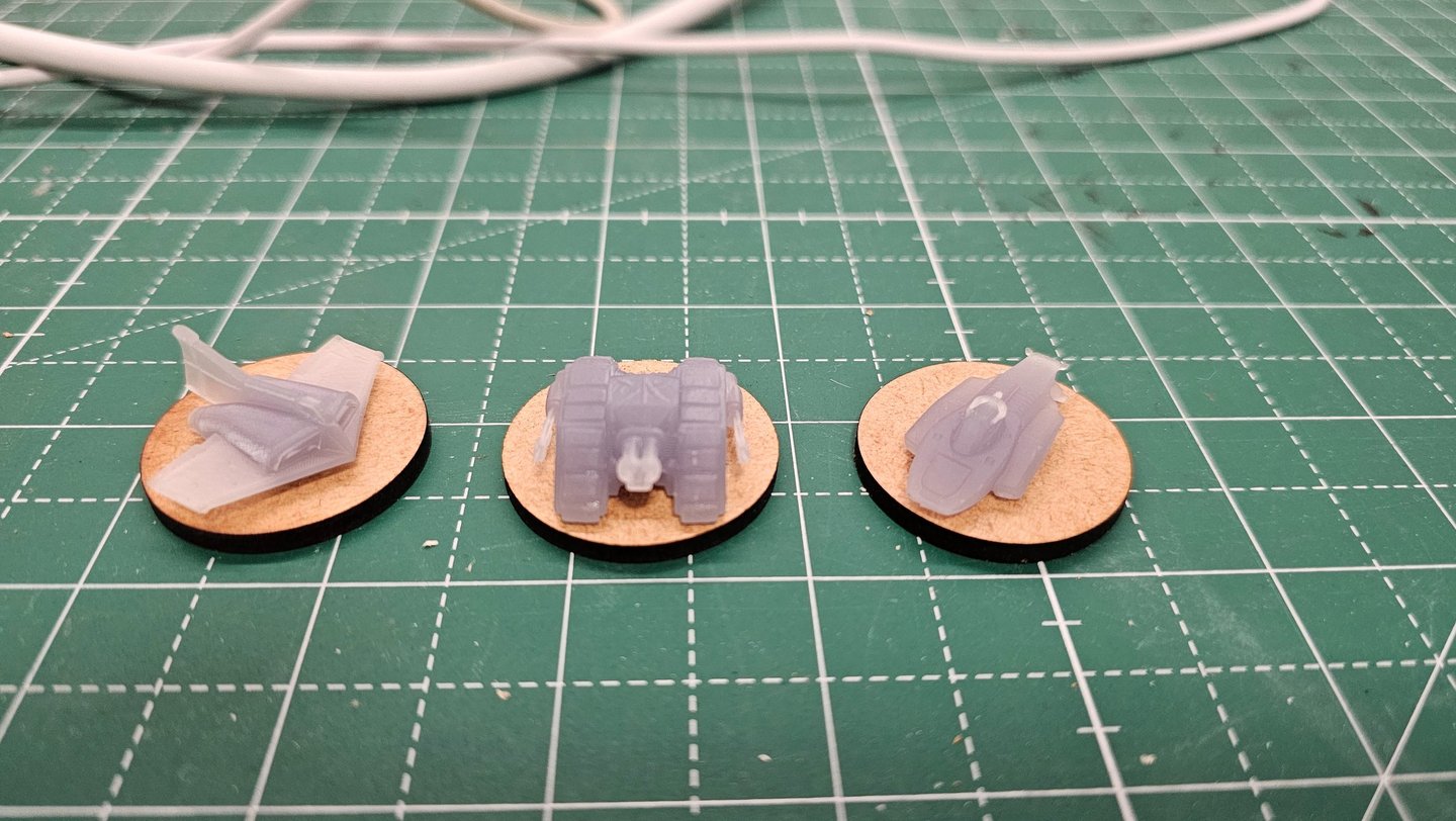 a pair of small plastic toy cars on a table