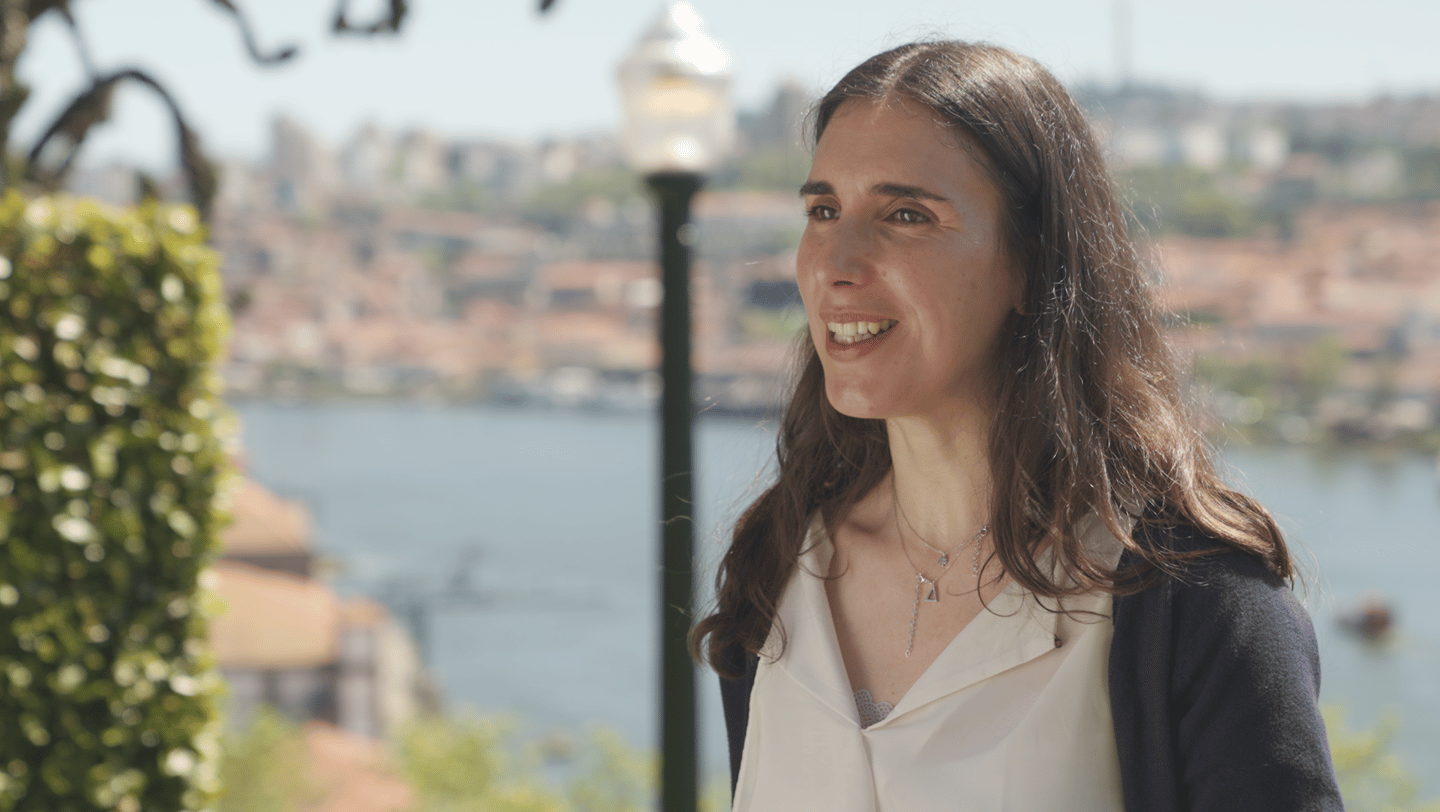 A woman, RIta Gomes, in a white shirt and a black jacket