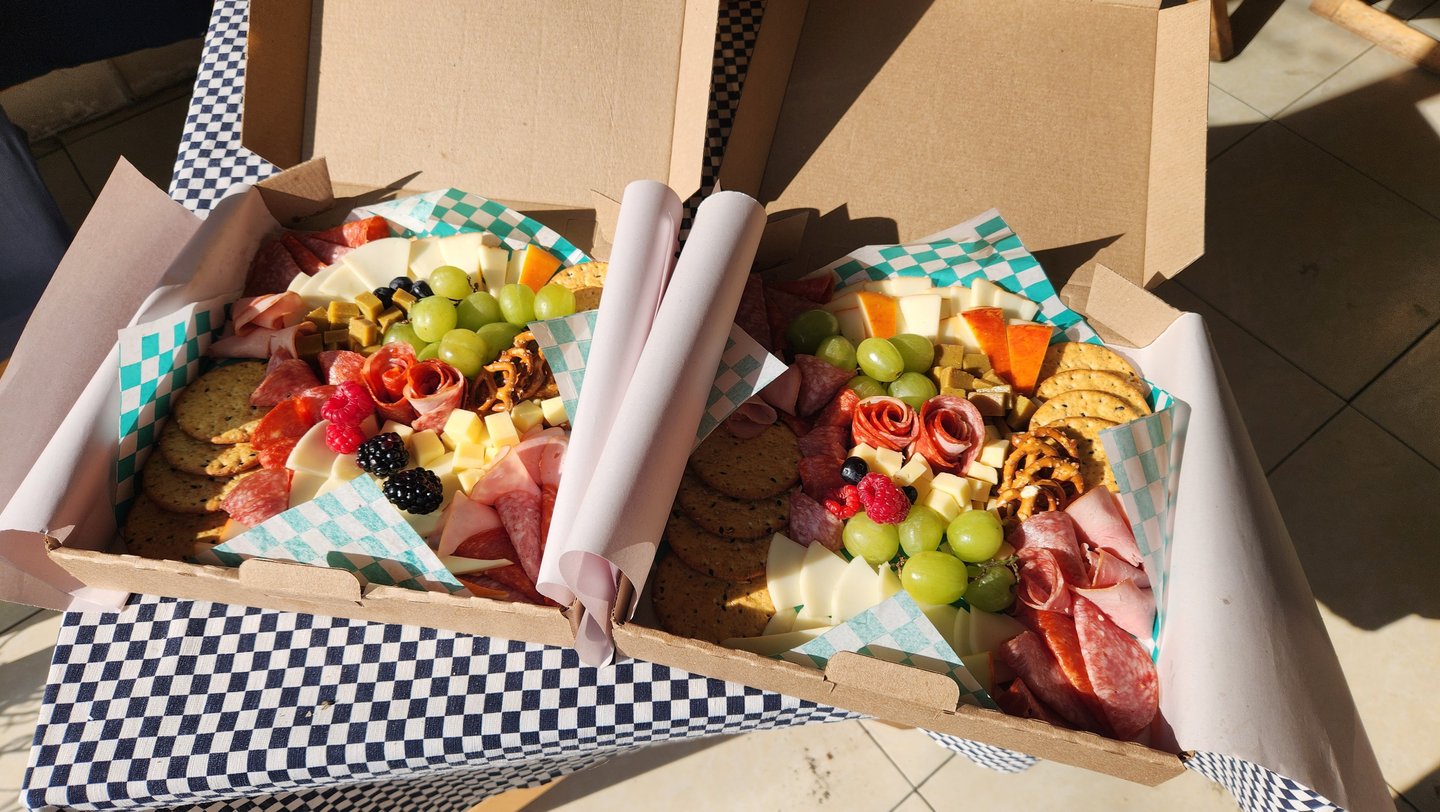 a box of food in a box with a checkered table cloth