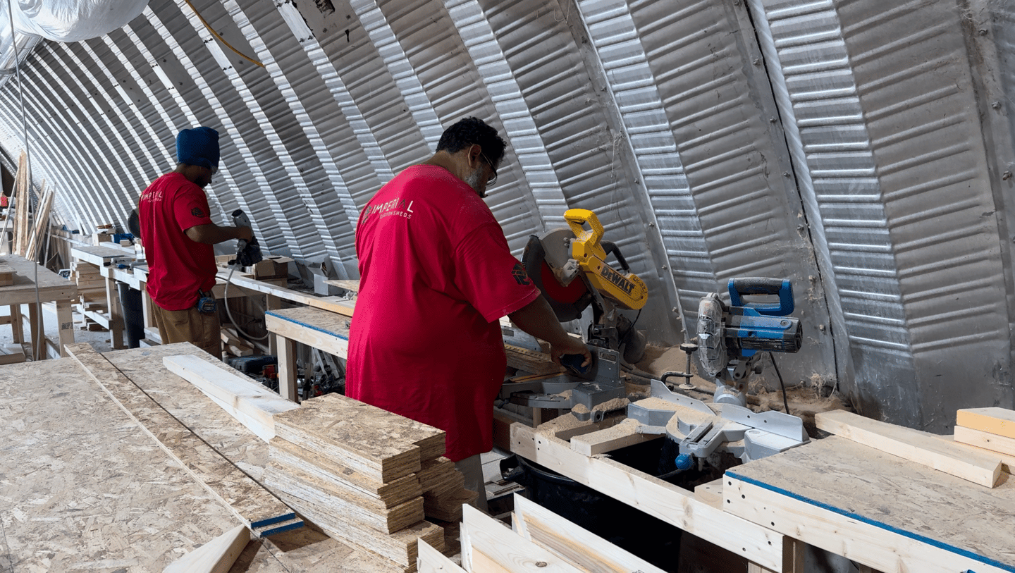 Imperial Custom Sheds crew fabricating custom shed components in workshop