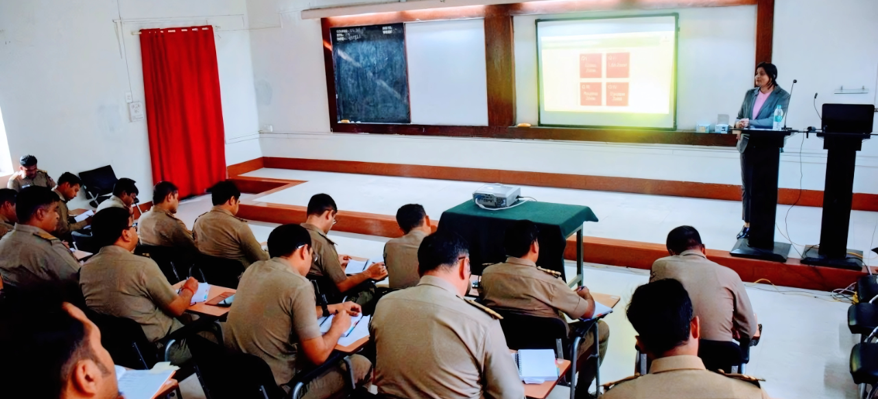 Trainer presenting to uniformed professionals during a classroom session.