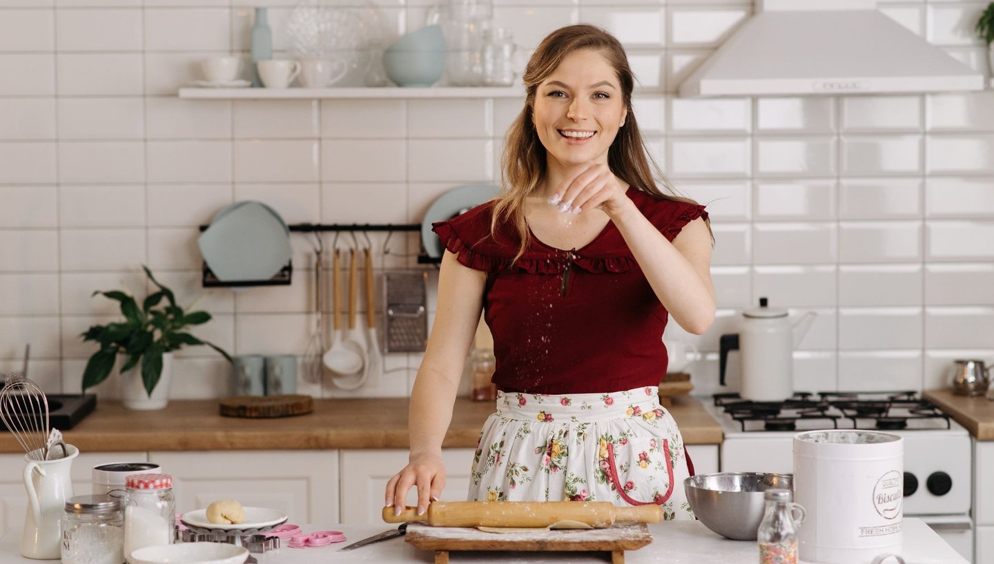 a woman in a red shirt is holding a rolling pinwheel