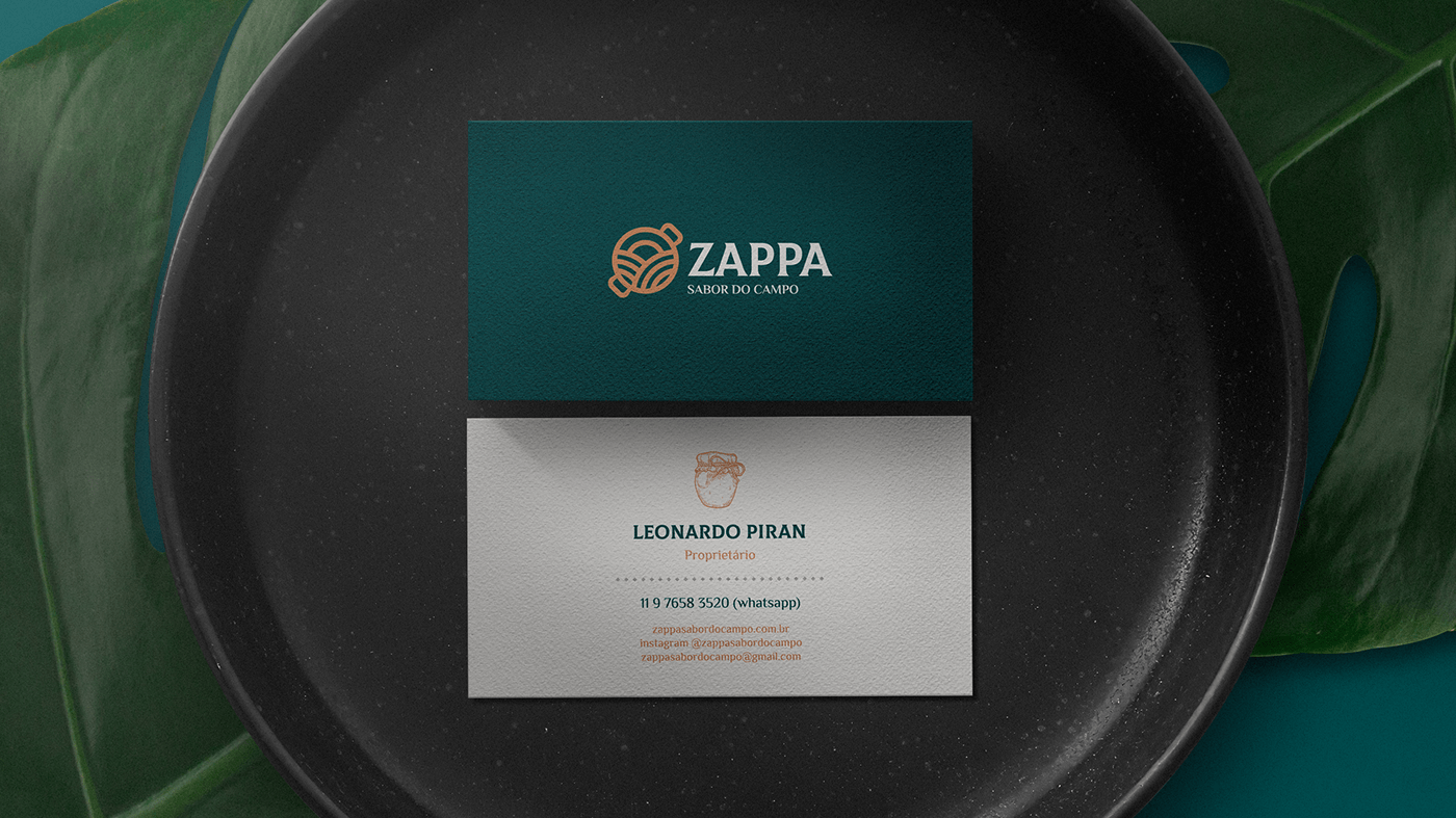 business card with zappa visual identity under a black plate and green leaves