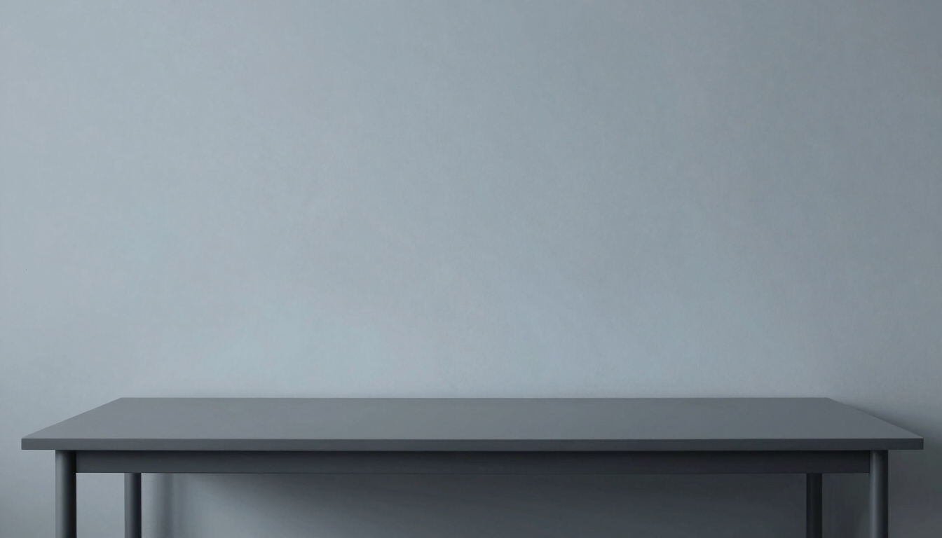 Minimalist developer workspace with clean lines, soft diffused daylight, graphite gray and slate blue tones, architectural composition