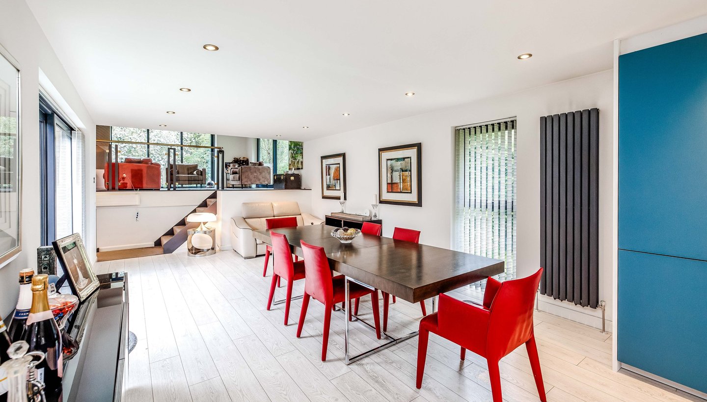 a dining room with a table and chairs
