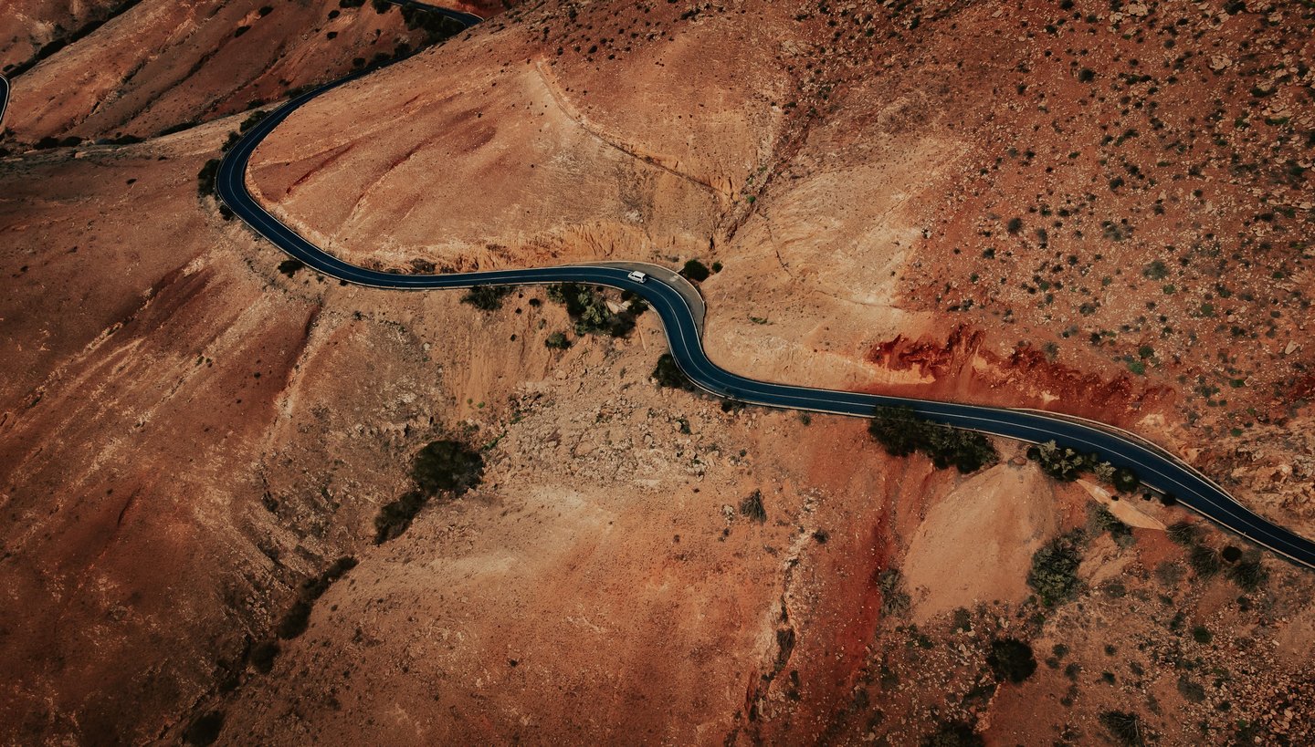 a winding road in the desert 