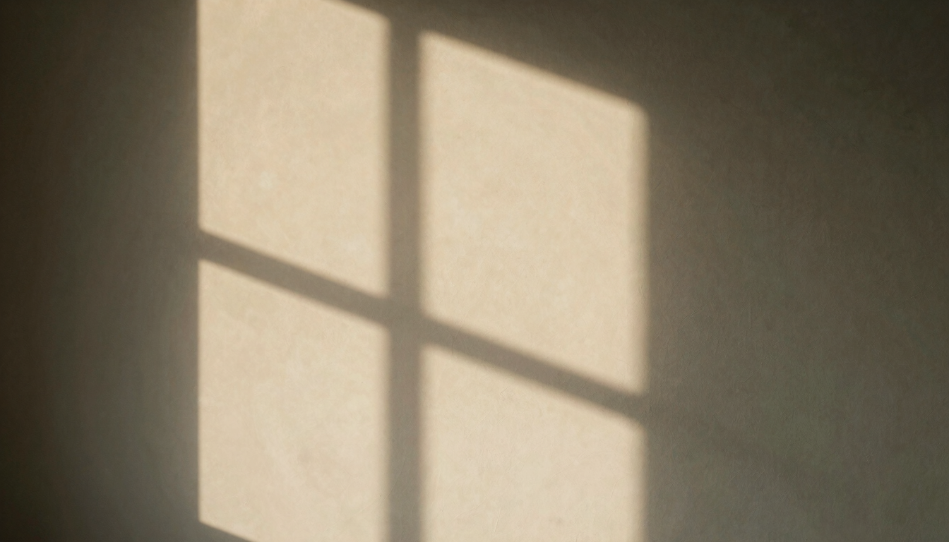 Abstract shadow of window panes falling on a warm plaster wall, quiet minimalist composition, architectural feel