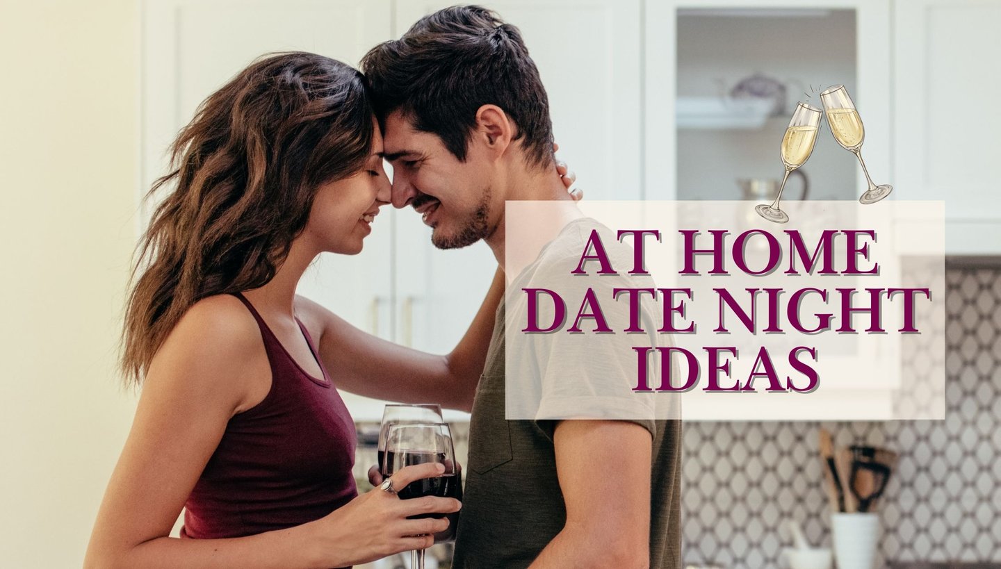 a man and woman standing in a kitchen with a glass of wine