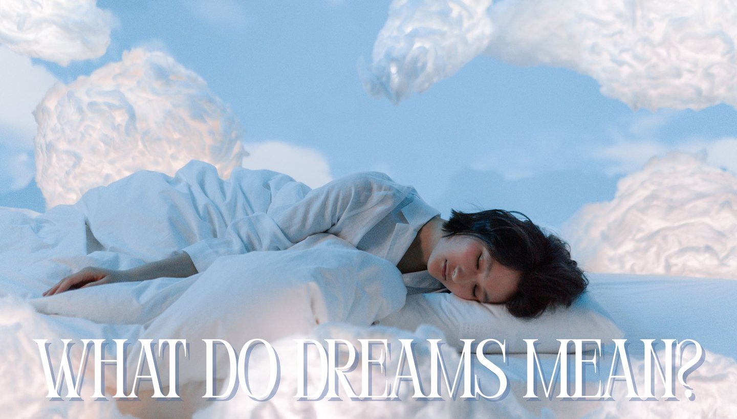 a woman laying on a bed with a sky background
