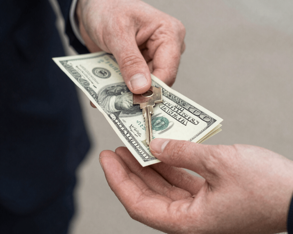 A close-up of a transaction, hands exchanging cash for car keys in front of an older vehicle, bright natural daylight, realistic 35mm documentary style
