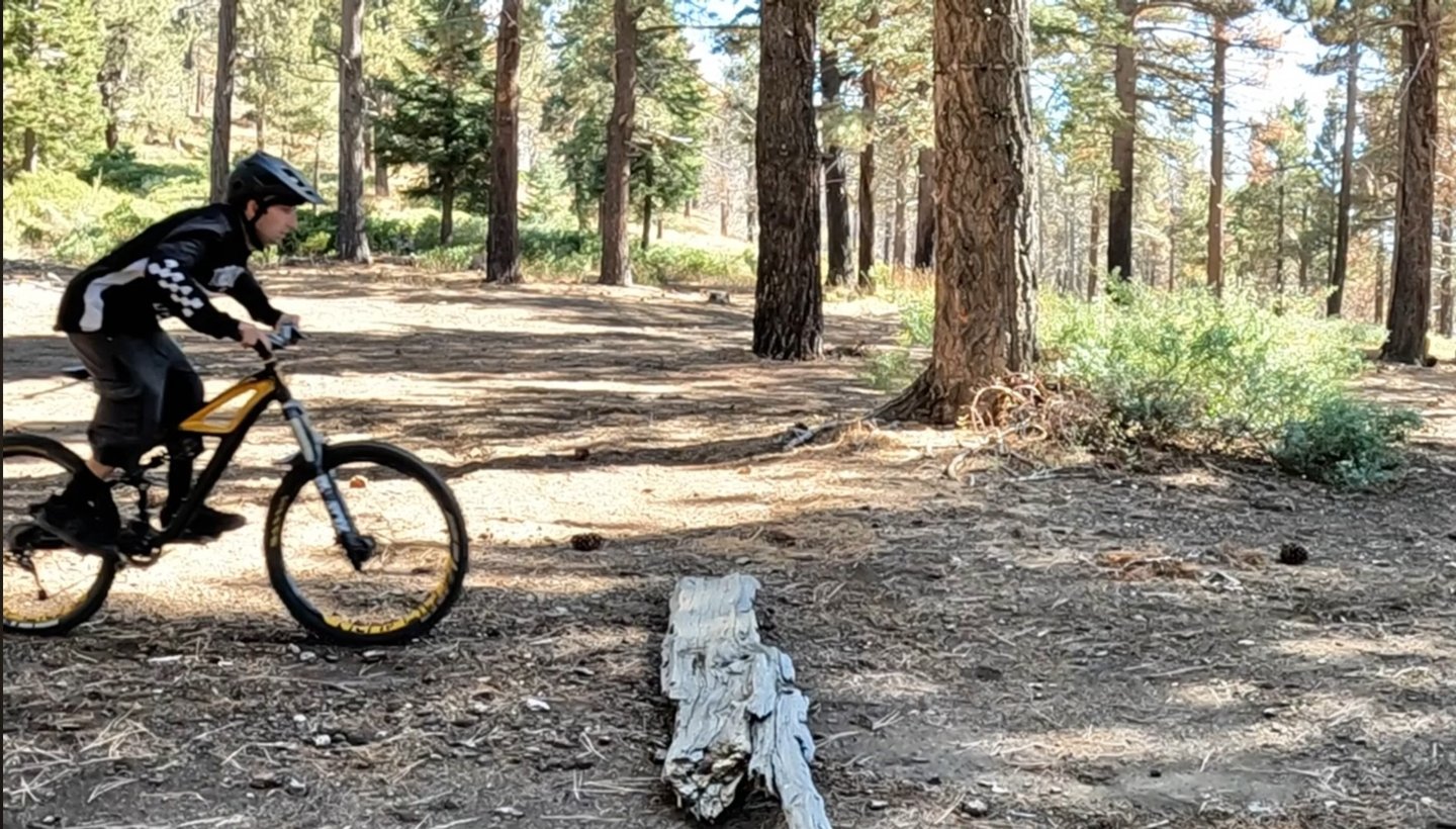 mountain biker preloading body to do the bump jump technique