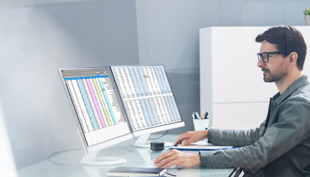 Professional RW West project manager coordinating a commercial facility inspection report at a modern workstation