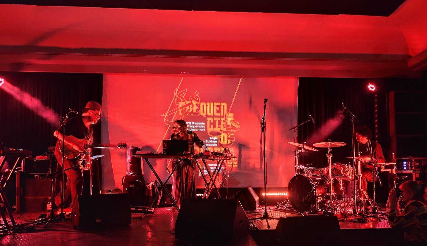 a band playing music on stage at a concert