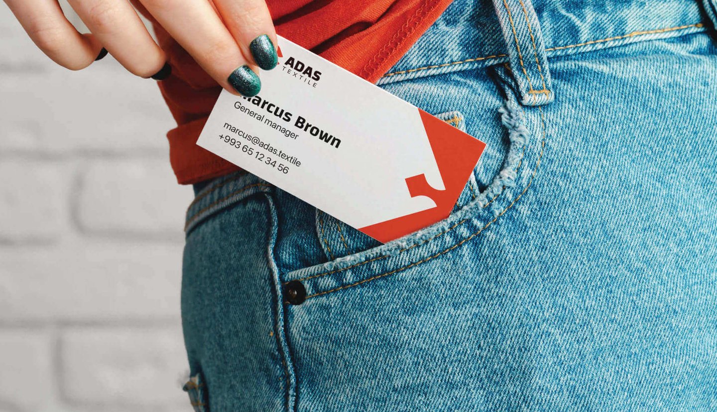 a woman's hand holding a business card