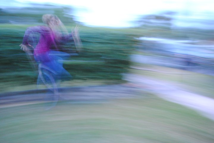 a blurred photo in color of author Dawn Davies leaping in the air