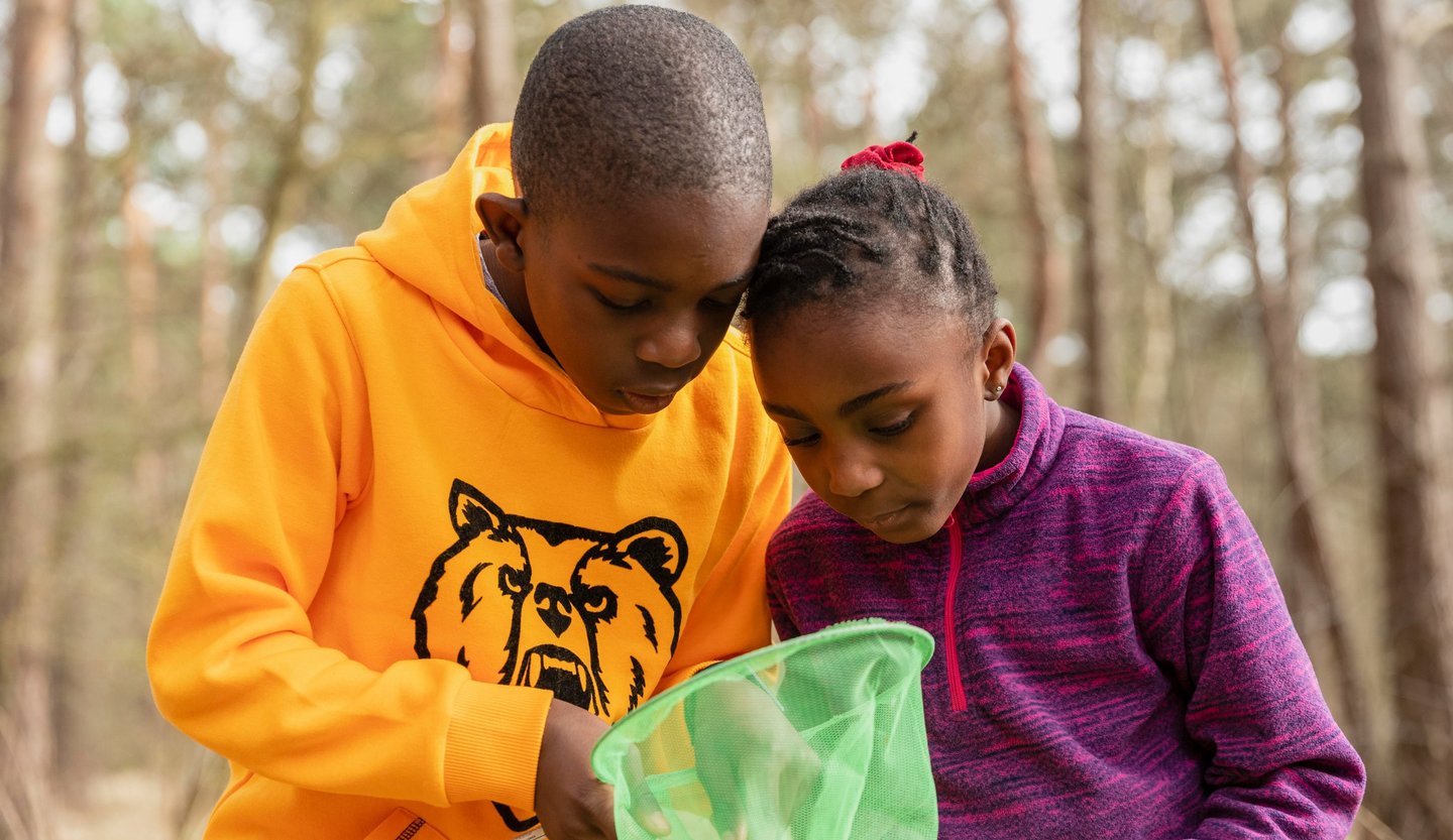 Two children exploring fishing nets