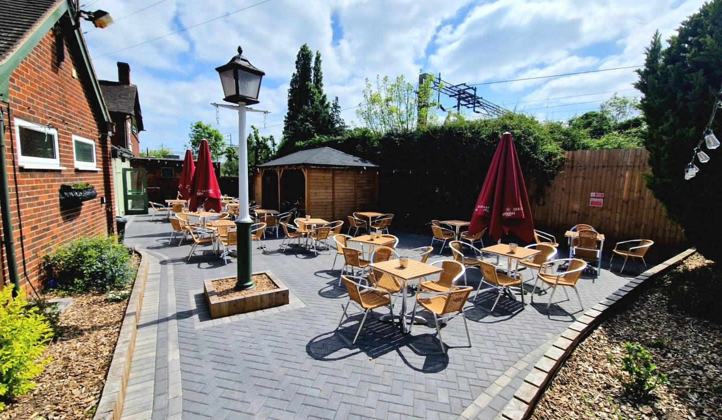 a patio with tables and chairs and umbrellas