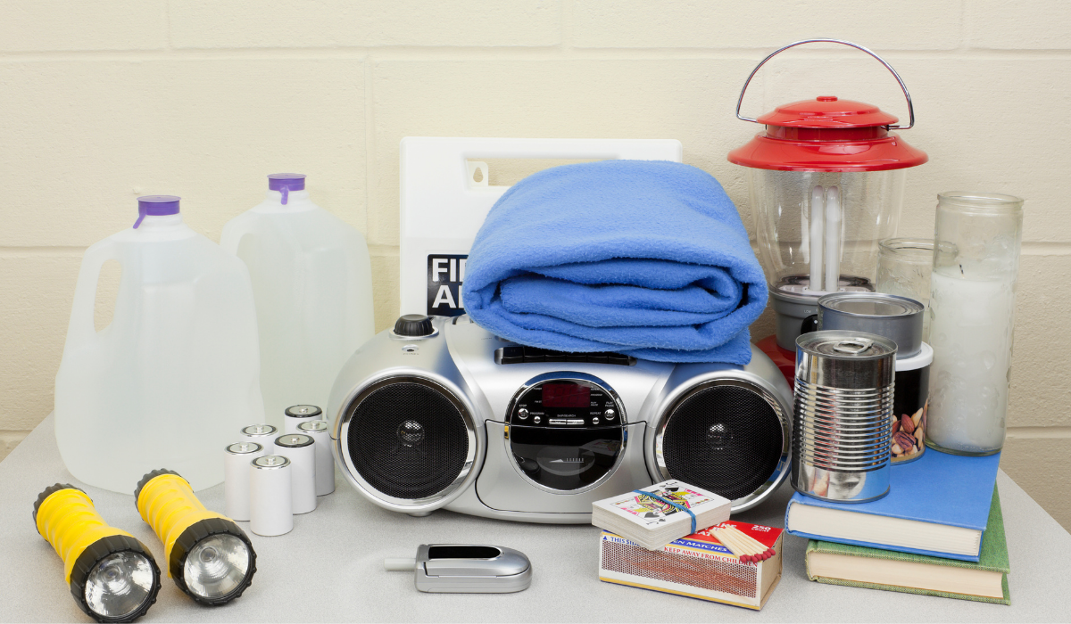 Florida hurricane supplies with water jug, radio, blanket, flashlights, candle, matches, first aid 
