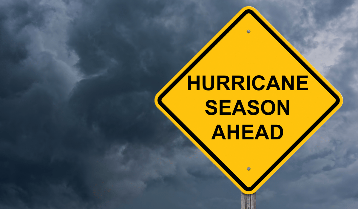 Yellow sign in stormy weather that says, Hurricane season ahead