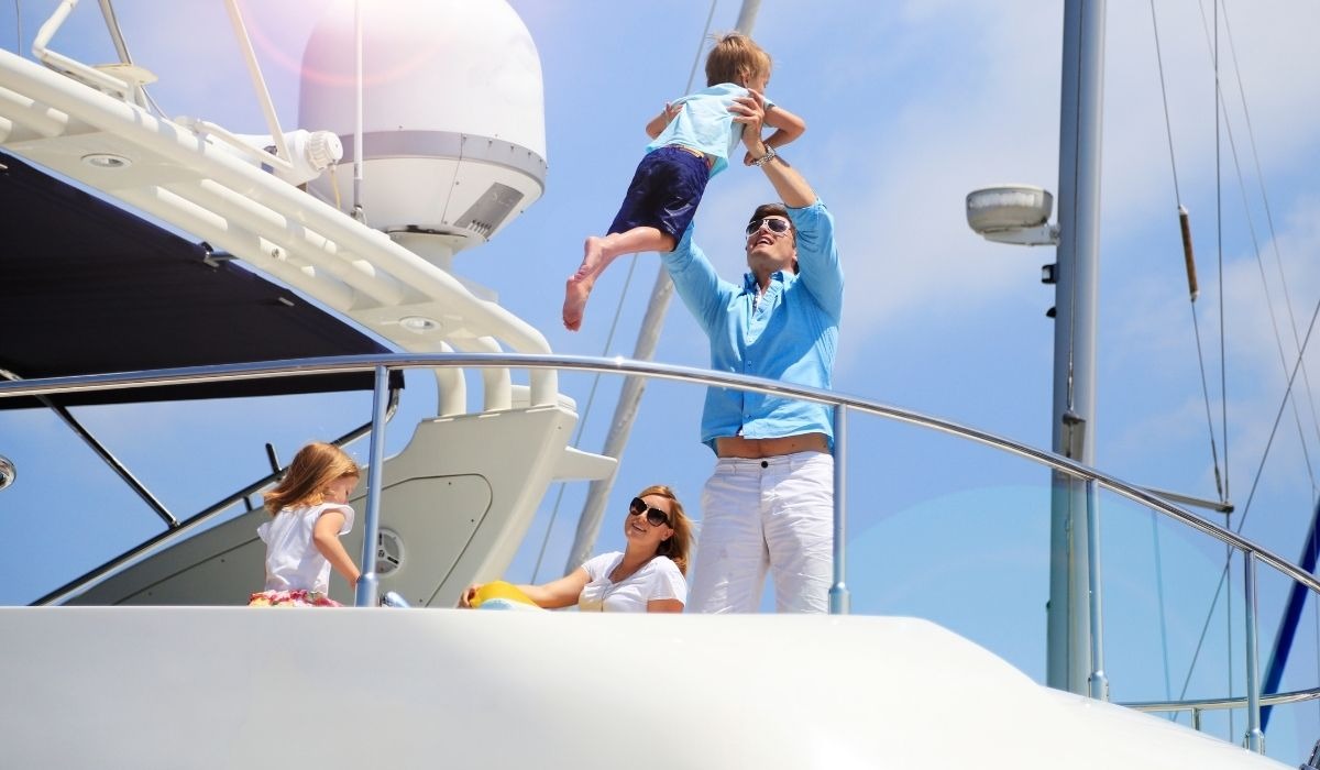 family on large yacht having fun