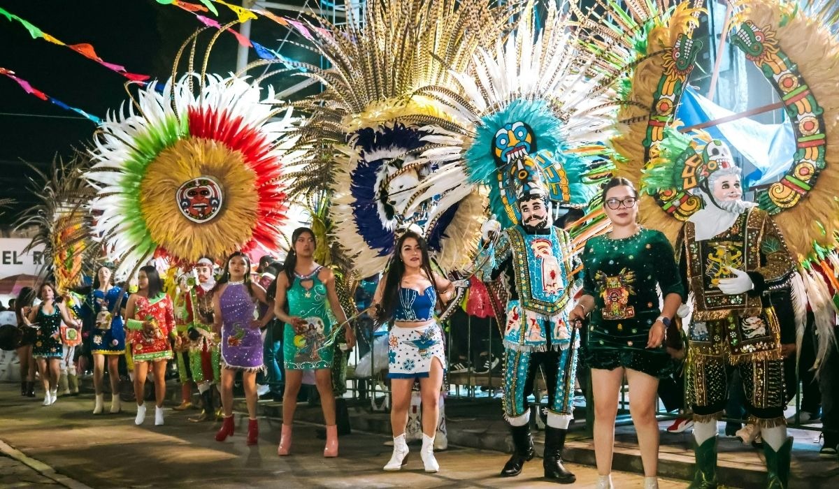 colorful parade with people standing on a float