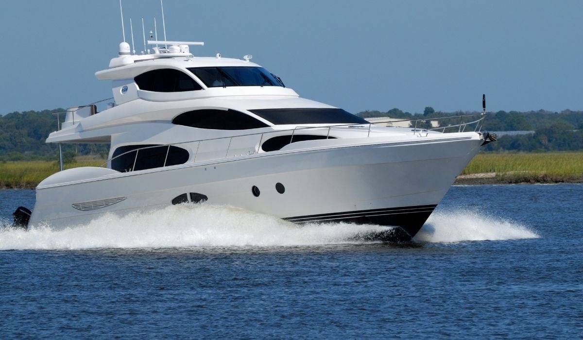 large white yacht running through water