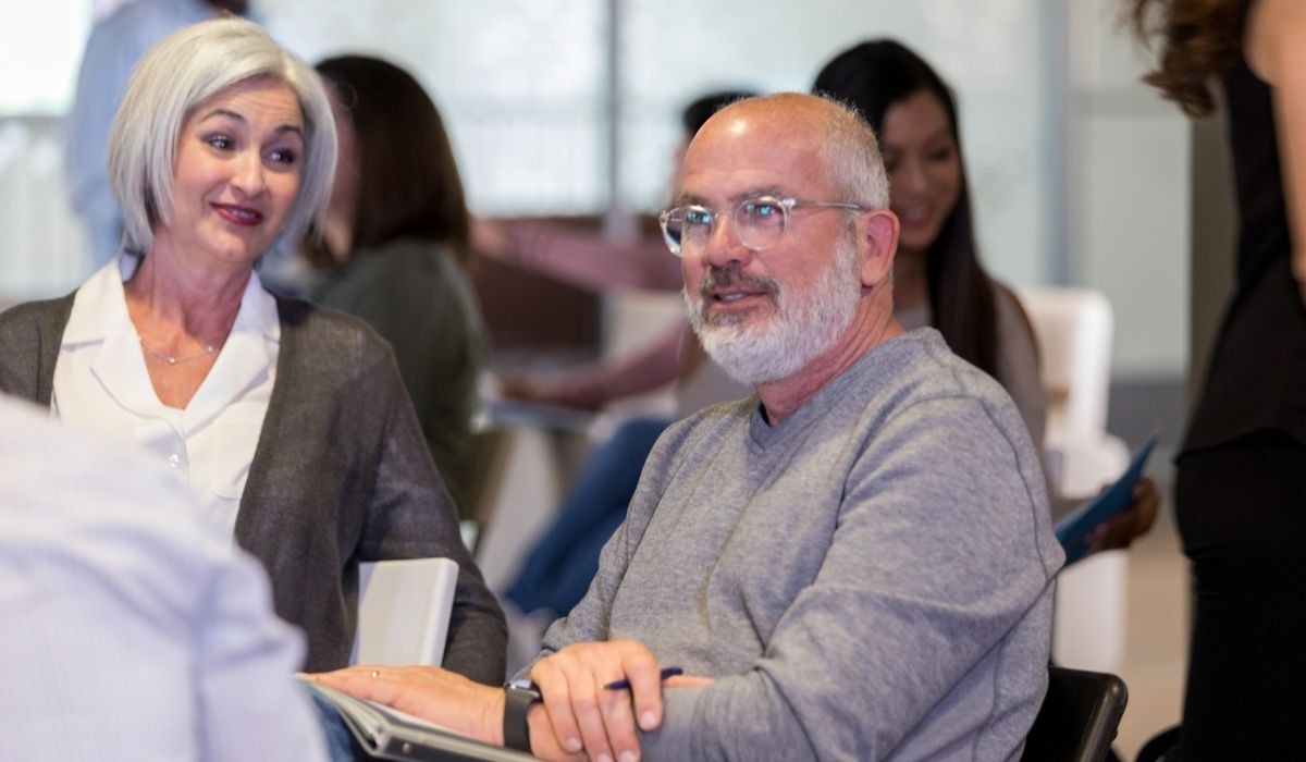 woman and man talking at a meeting