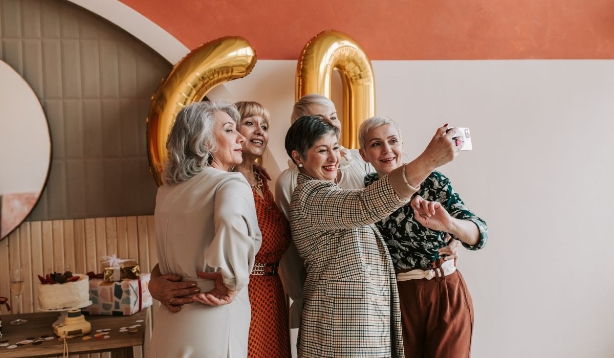 senior women celebrating friend's 60th birthday