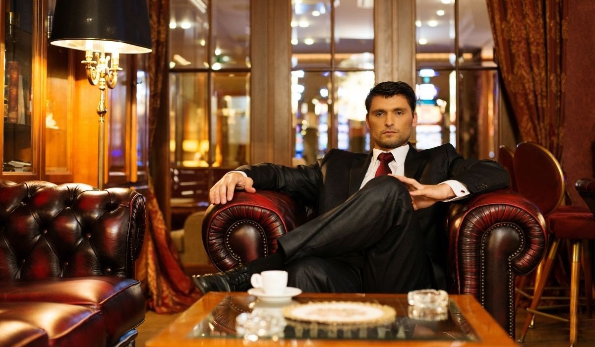 wealthy young man sitting in a rich office